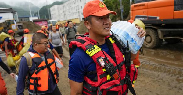 Firefighters trek uphill to aid stranded residents in Beijing after heavy rains